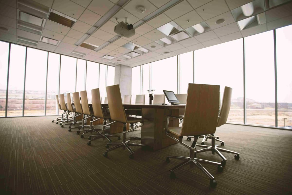 a boardroom table with papers and a gavel absent, alt text "Directors’ duties in Kenya under the Companies Act, 2015 — the obligations and personal liability of company directors